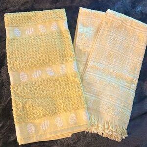 Three towels, 2 yellow and one green.